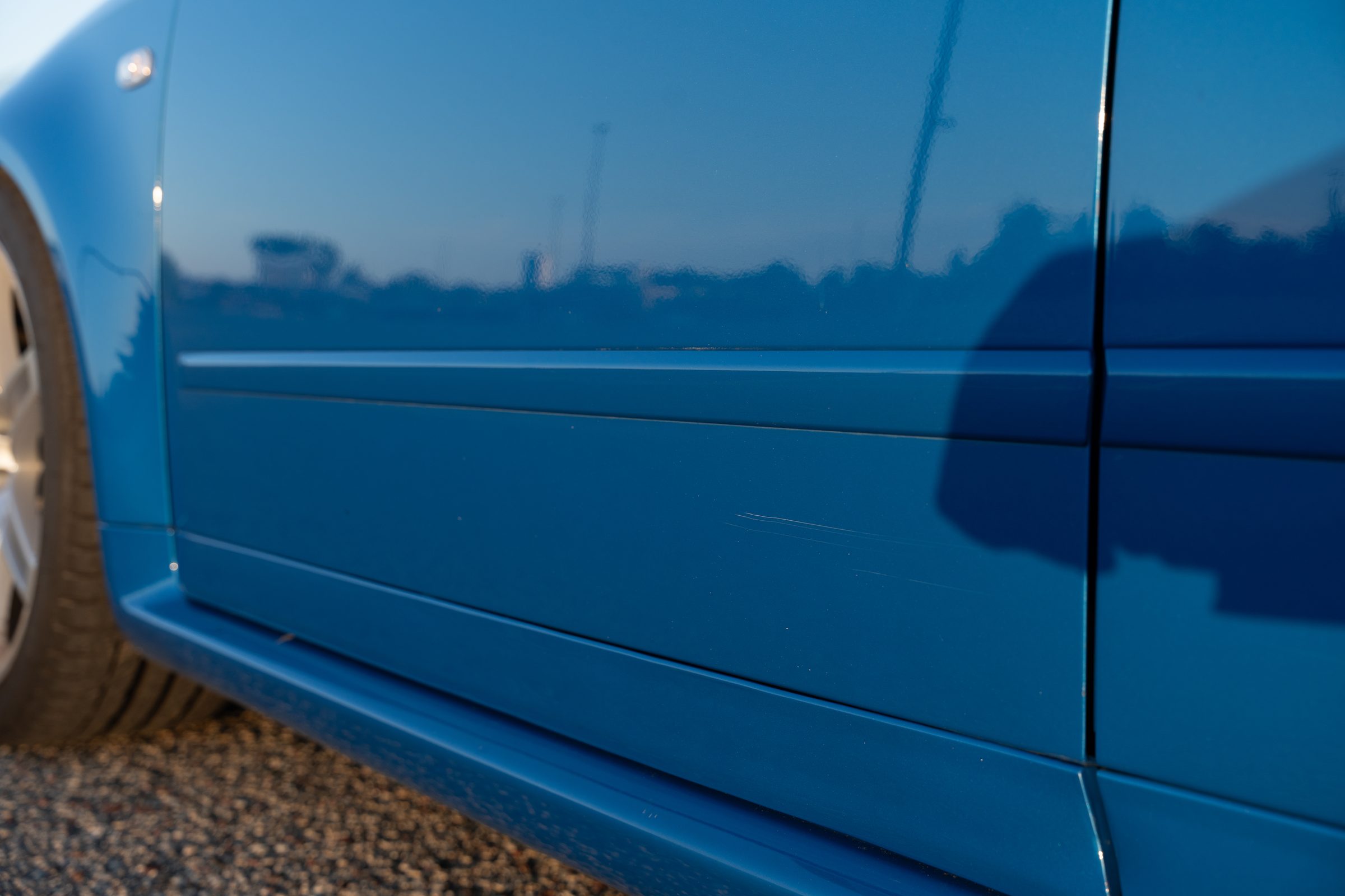 Close-up of a light scratch on the rocker panel