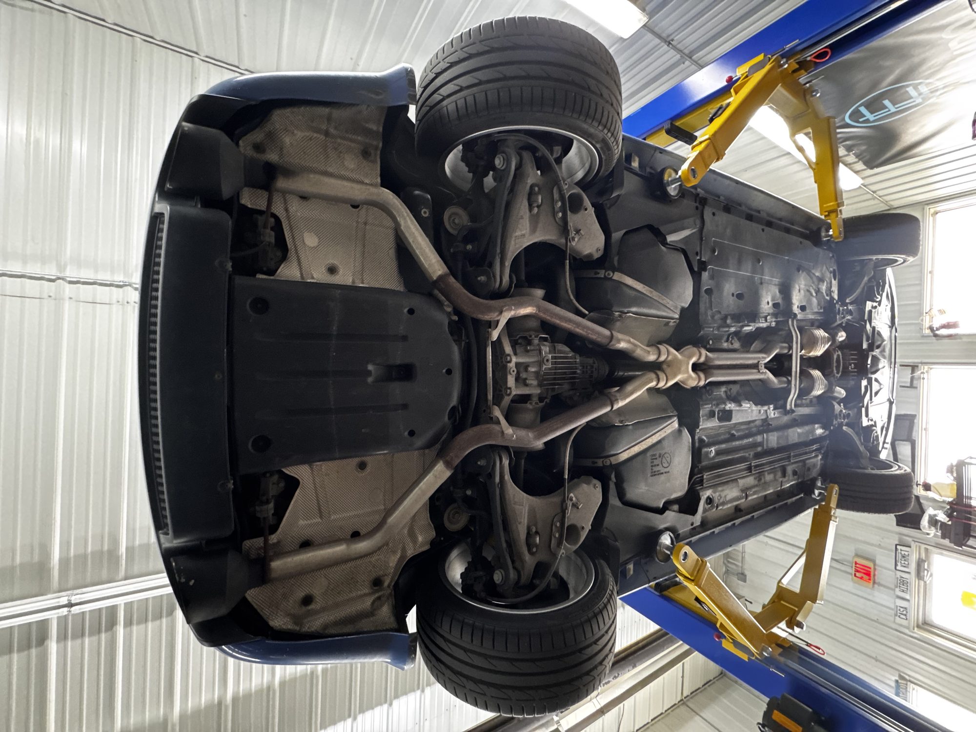 Underbody view from behind, showing rear subframe, differential, and dual exhaust
