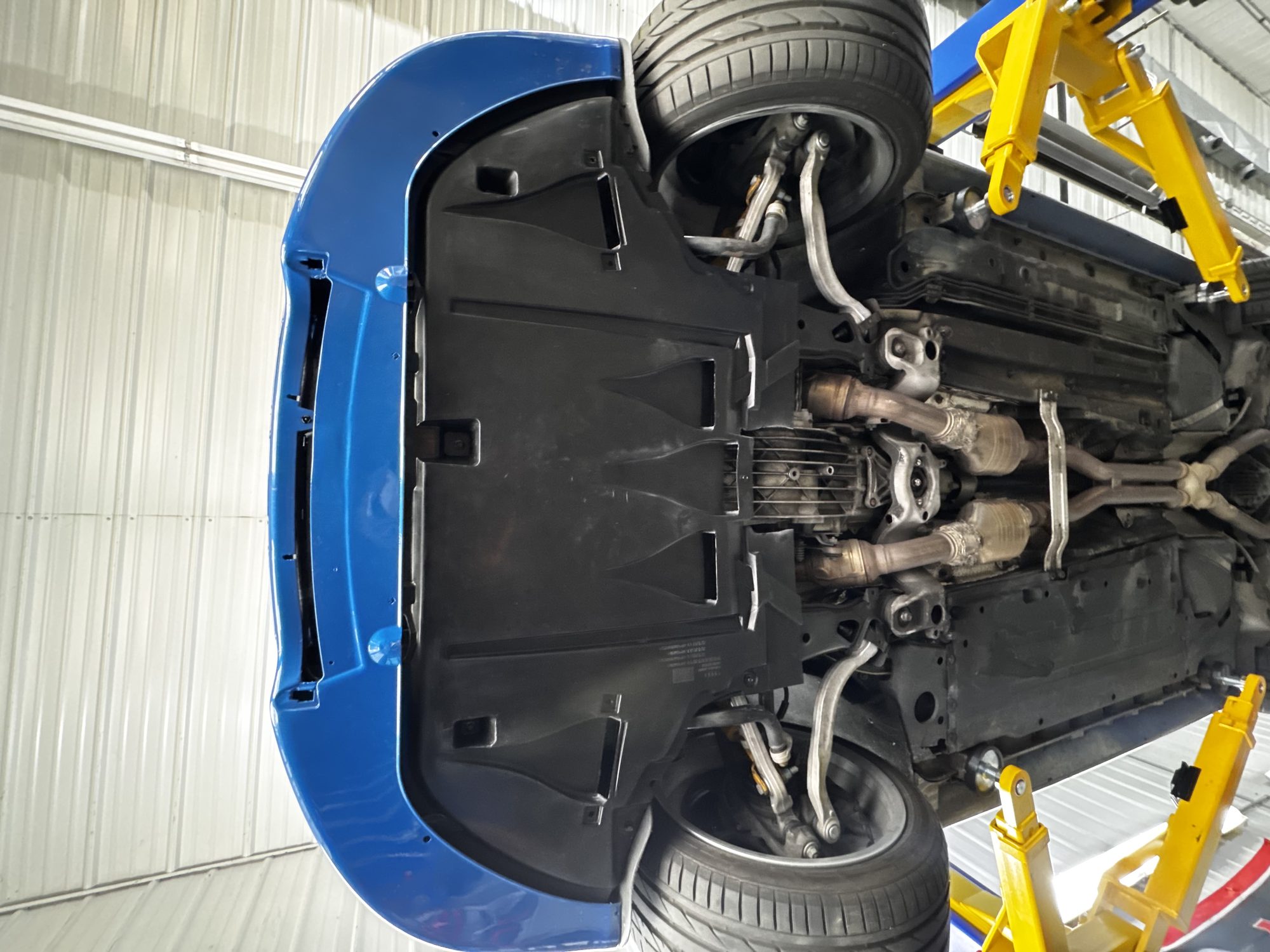 Underbody view showing rear suspension, skid plate, and exhaust